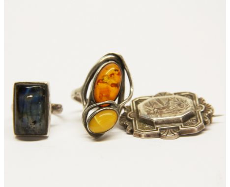 A 925 silver amber set ring with a further 925 silver stone set ring and a hallmarked silver brooch.