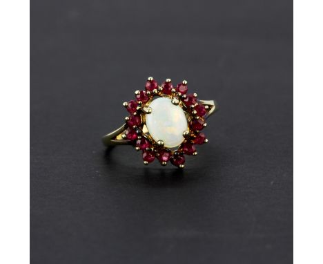 A 9ct yellow gold ring set with opal and rubies, (T).