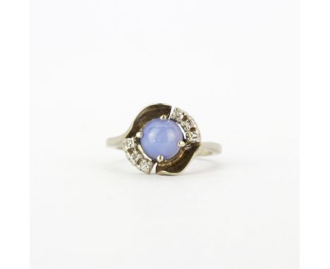 A 10ct white gold (stamped 10k) ring set with a cabochon cut star white sapphire and brilliant cut diamonds, (M.5).