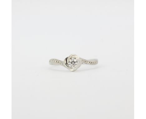 A 9ct white gold (stamped 9k) solitaire ring set with a brilliant cut diamond and diamond set shoulders, (K.5).