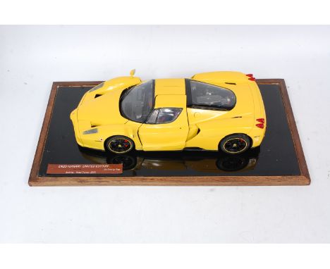 A well made 1/12th scale model of a Ferrari Enzo, finished in yellow, made from a Tamiya kit with added detail, in a glass di