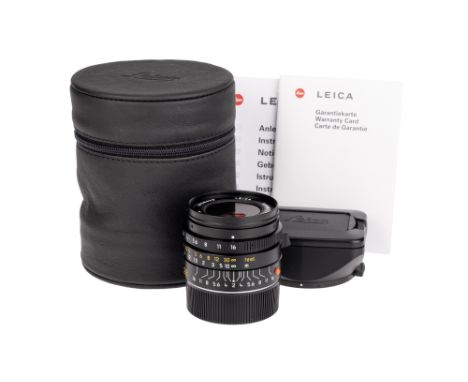 A Leitz Summicron-M ASPH. f/2 28mm Lens, black, serial no. 3928620, body, E, elements, VG-E, complete with lens hood, maker's