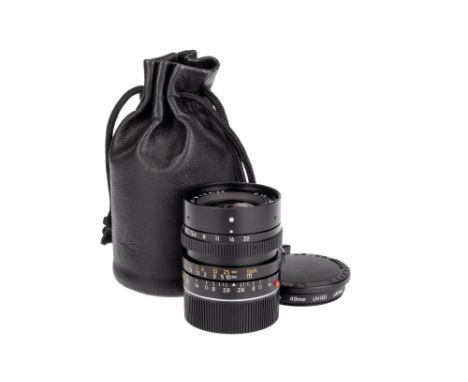A Leitz Elmarit-M f/2.8 28mm Lens, black, serial no. 3558892, body VG-E, optics VG, with front &amp; rear caps, also with a l