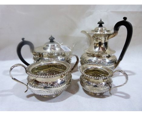 A Edward VI four piece silver tea service, gadrooned and half-fluted with repousse ribbon ties and garlands. Sheffield 1909. 