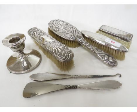 THREE SILVER CLAD CLOTHES BRUSHES, DRESSING TABLE BOX WITH SILVER LID, SILVER CLAD CANDLE STICK AND TWO BOOT TOOLS WITH FILLE