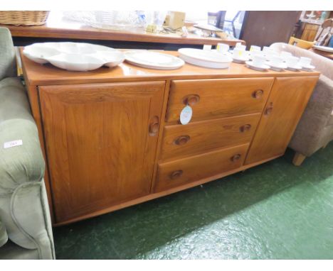 ERCOL LIGHT ELM SIDEBOARD WITH THREE CENTRAL DRAWERS AND CUPBOARD TO EITHER END, STANDING ON CASTORS