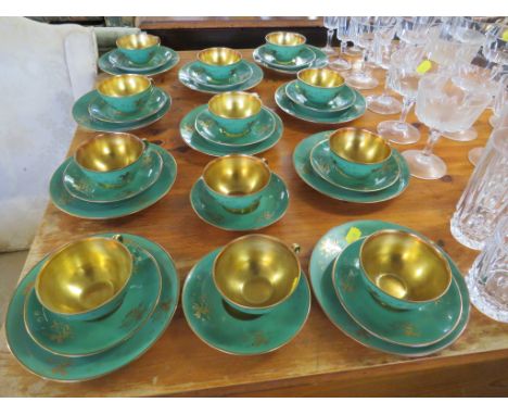 SWEDISH KARLSKRONA HALD PORCELAIN TWELVE CUPS AND SAUCERS AND TEN SIDE PLATES, GREEN AND GILT DECORATED WITH CHERUBS IN CLOUD