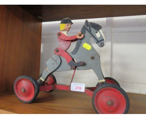 VINTAGE PULL ALONG TOY OF HORSE AND RIDER WITH FOUR WHEELS (SOLD AS AN ANTIQUE ITEM ONLY)