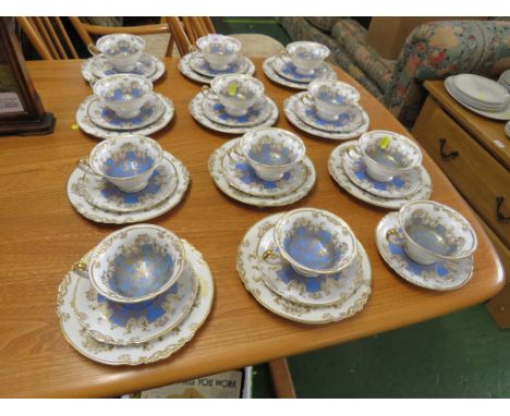 ROYAL PORCELAIN TETTAU TEA SERVICE IN WHITE BLUE AND GILT, WITH TWELVE TEA CUPS AND SAUCERS AND ELEVEN TEA PLATES