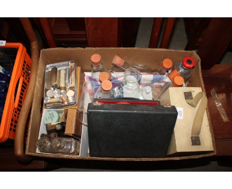 A box containing various vintage medical items, laboratory flasks etc.