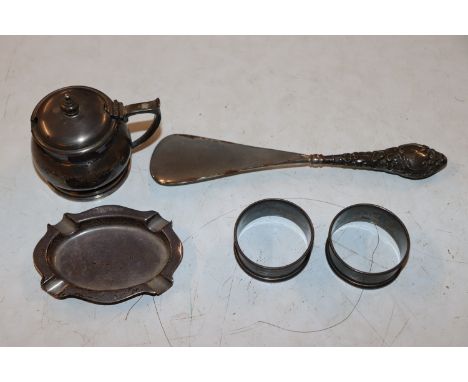 A silver mustard; a small silver ashtray; two silver napkin rings approx. total weight excluding glass liner 125gm; a silver 