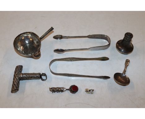 A pair of Georgian bright cut sugar tongs; another pair of silver sugar tongs; a silver caddy spoon; a silver pepper pot AF, 