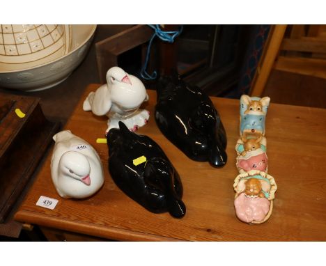 A pair of porcelain dove ornaments; two porcelain duck ornaments and three Pendelfin rabbits