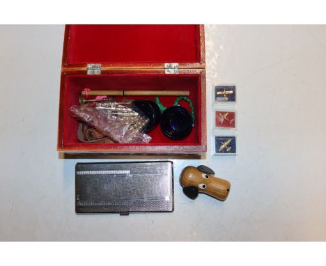 A carved wooden Romanian box and contents to include a pin in the form of Concorde; cigarette case etc.