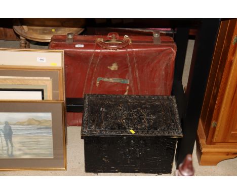 A vintage leather suitcase and an embossed coal box