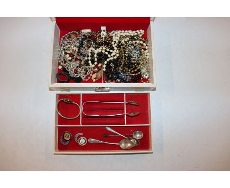 Two silver coffee spoons; a silver tea spoon; a pair of silver plated sugar tongs; various costume jewellery contained in a j