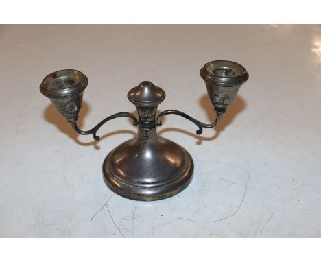 A Birmingham silver twin branch candlestick by Sanders & Mackenzie, having weighted base total weight 255gm