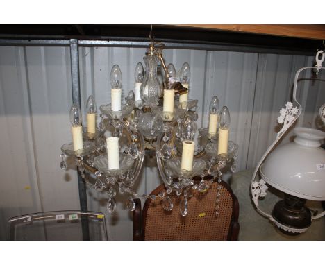 A glass twelve light chandelier with prism drops AF