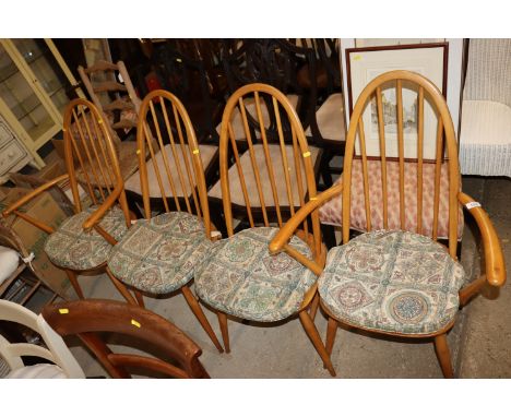 A set of four blonde Ercol stick back dining chairs, (two standards and two elbows)