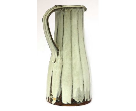 *Jim Malone (b.1946),a stoneware facet jug, with a cream trailing glaze, impressed artist's monogram and Ainstable mark,36cm 