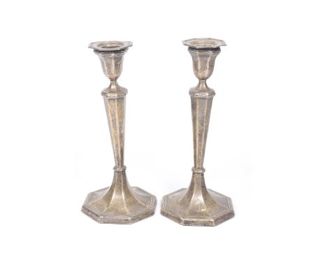 A pair of George VI silver candlesticks Of faceted form, rising from a spreading circular base, 20cm high, Harrison Brothers 