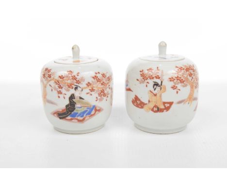A pair of Japanese lidded pots, early 20th Century Of rounded form with integrated flat cover, enamel in vibrant iron-red dep