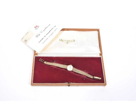 Longines: A Ladies 9k gold manual wind bracelet watchThe silvered dial with applied gold tone baton hour markers, fitted to a