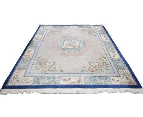 A Chinese style embroidered wall carpet The blue edging with alternating panels filled with lotus and birds with traditional 