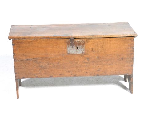 A 17th Century oak six plank cofferHaving a plain front board raised upon V cut bracket supports, 94x51x36cm.