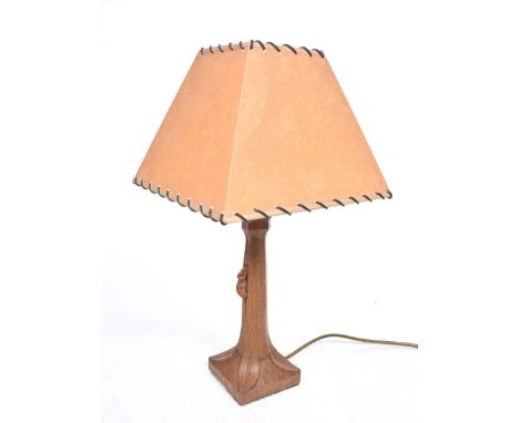 A Robert 'Mouseman' Thompson stained oak table lamp Of square section, the faceted tapered stem carved with signature mouse d