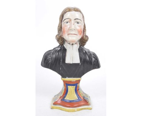 A Staffordshire Pearleware figure of John WesleyThe iridescent glazed and polychrome enamelled bust raised on plinth base wea