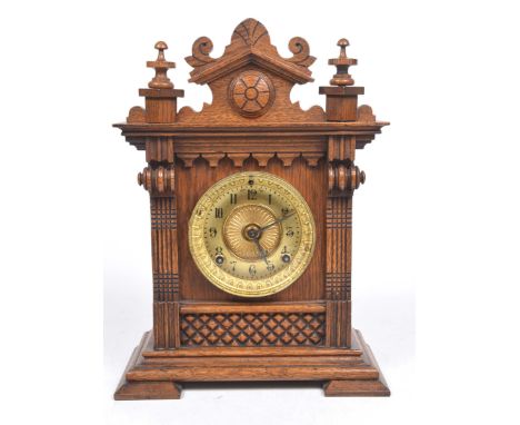 An Edwardian oak cased mantle clock13cm gilt metal style with Arabic numerals and glazed door, the works stamped 'Ansonia clo