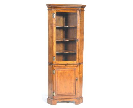 A lovely quality free standing cheery wood corner display cabinet Having a moulded cornice above a single glazed door enclosi