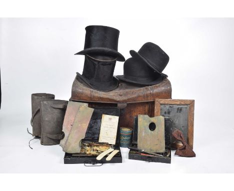 A collection of old hats in a tin trunk To include two bowler hats, two silk top hats, a metal artist boxes and leather gater