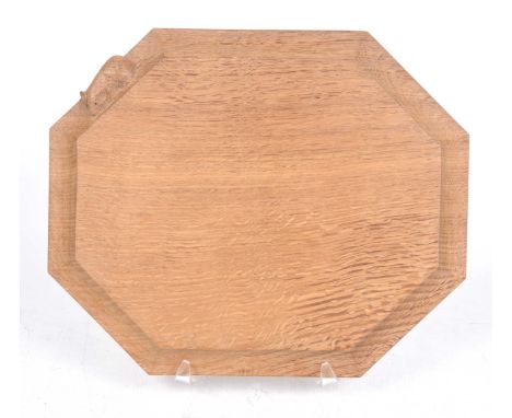 A Robert 'Mouseman' Thompson carved oak breadboard Of octagonal form, the swept sides carved with typical mouse signature, 30