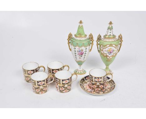 A matched pair of Royal Crown Derby twin handled vasesEach of flattened ovoid form detailed with floral sprays reserved again