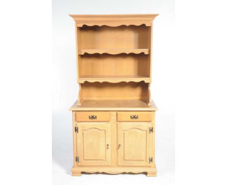 A modern Beech effect kitchen dresserThe high back with two enclosed shelves above the base with two frieze drawers over two 