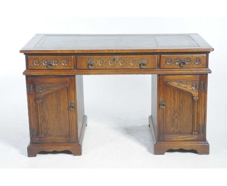 A good quality reproduction oak twin pedestal deskHaving a green leather and gilt tooled leather inset writing surface above 