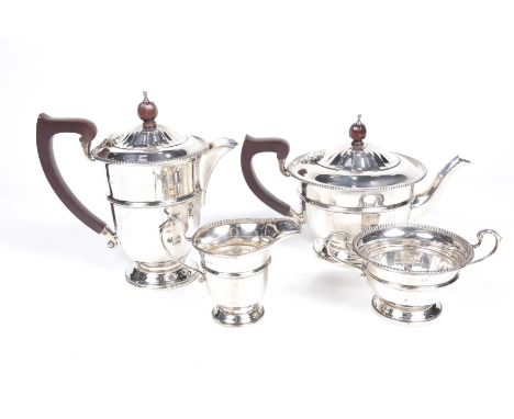 A silver George V four piece tea serviceTo include tea pot, hot water jug, milk jug and twin handled sugar bowl, applied with