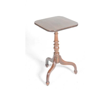A mid 19th Century mahogany lamp tableThe square top with rounded corners supported on ring turned baluster shaft with three 