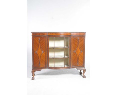 A 1920's mahogany Chippendale revival display cabinetThe breakfront top with a gadroon border above a single convex glazed do