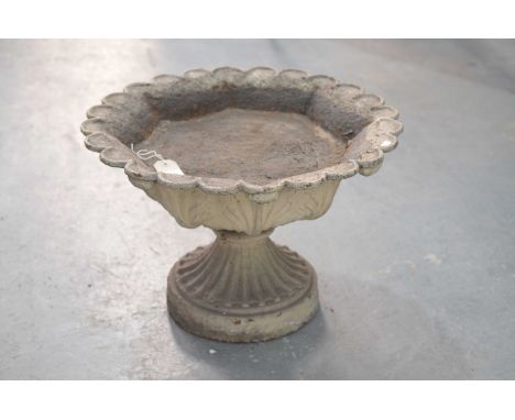 A late 19th Century painted iron planterThe leafy cast shallow planter with a scalloped border raised on a reeded support and