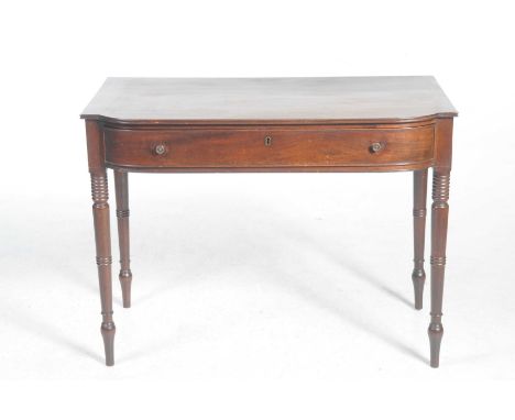 A late Georgian mahogany side table Having a bowfront top with a single frieze drawer applied with metal button handles, and 