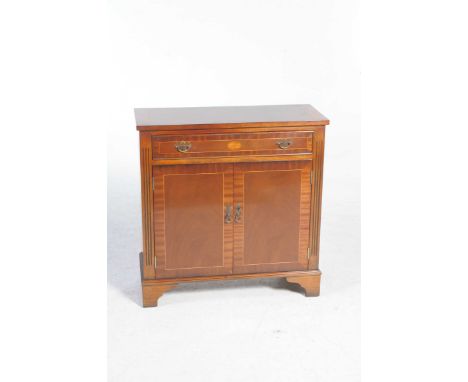 A Georgian style reproduction mahogany side cabinetThe single frieze drawer centred with an oval inlaid fan above a pair of c