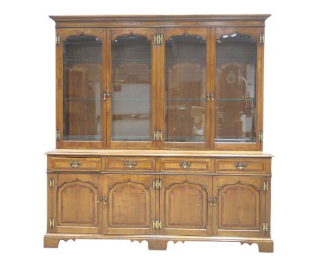 A good quality reproduction cherry wood Georgian style glazed bookcaseHaving a moulded cornice above four shaped glazed and b