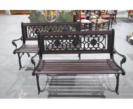 A pair of iron and slatted hardwood garden benchesEach with an iron openwork back panel above a slatted seat raised on two ir