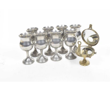 Eight English pewter goblets and a brass nautical compass The goblets of typical baluster form, along with a compass with hin