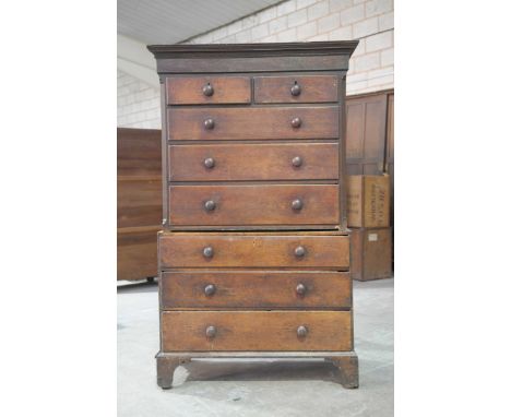 A substantial 18th Century oak chest on chestWith a moulded cornice above a plain frieze, two short and three long graduated 