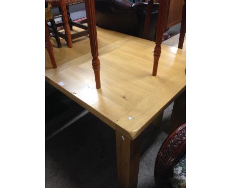 A MODERN LIGHT OAK DINING TABLE