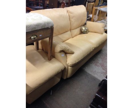 A YELLOW LEATHER SOFA WITH MATCHING POUFFE